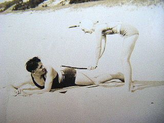 1920s bathing beauty spanks man on bottom with stick C