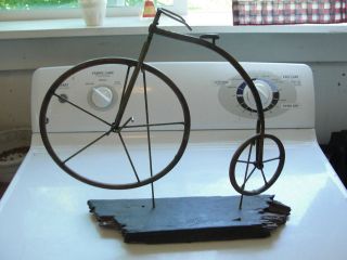 Copper penny farthing, high wheel bicycle on wood stand, decorative 