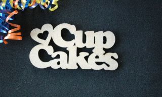 Wooden decorative joined letters making the word Cup Cakes with 