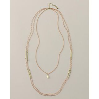 dainty glass pendant hangs from the shortest of three chains, while 
