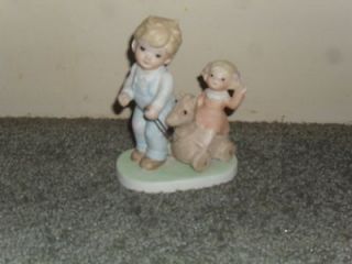 homco porcelain figurine of boy pulling girl on horse