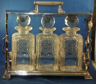 Three Bottle Tantalus. English Silverplate Frame with Cut Glass 