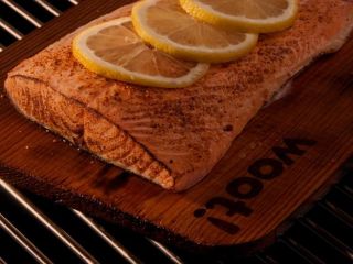 Salmon being cooked on a TrueFire Gourmet Cedar Grilling Plank
