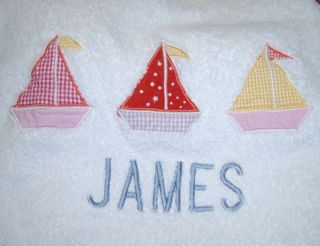   Towels appliqued with colorful sailboats and monogrammed with JAMES in
