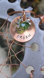 Completed with a concave hand stamped copper disc dream, gear and an