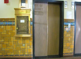 The old elevators have been upgraded but the original brass letterbox