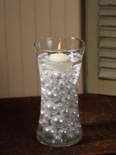 Ivory floating candles add that extra sparkle to your wedding, banquet