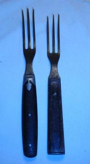 these are mid 1800 s 3 tine forks with wooden handles i would say