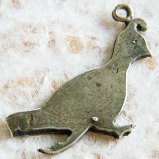 about the charm made of silver this gambell s quail charm appears to