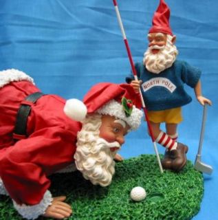  santa sizing up the putt playing golf with elf product description