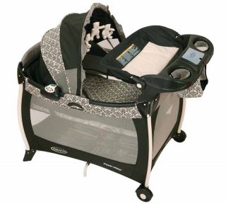 This playard features a quilted bassinet with dome canopy, as well as