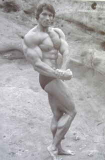 ARNOLD SCHWARZENEGGER YOUNG MUSCLE POSER BY ROCK CLIFFS POSTER